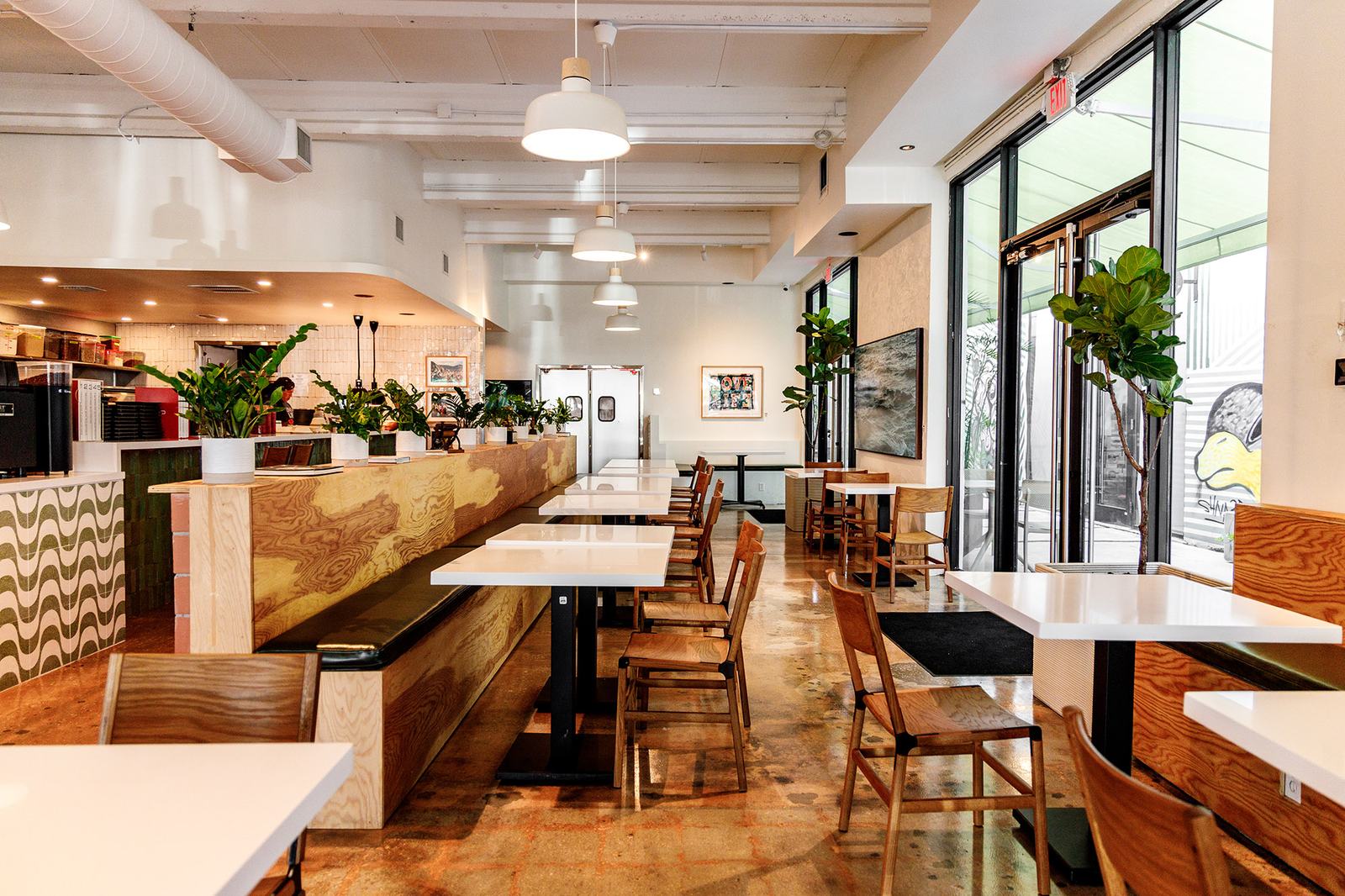 Our bright, modern cafe interior with a pizza oven and a wavy tiled counter.